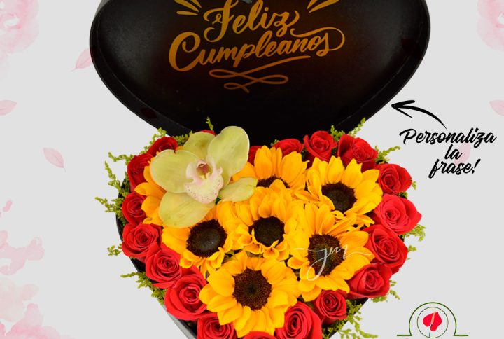 "Arreglo floral en forma de corazón con girasoles y rosas rojas, acompañado de una caja con mensaje 'Feliz Cumpleaños'."